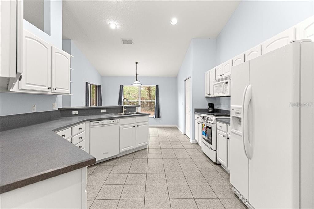 21595 Southwest 84th Loop Dunnellon, FL 34431 - Photo 12 of 62 a kitchen with stainless steel appliances a refrigerator sink and microwave