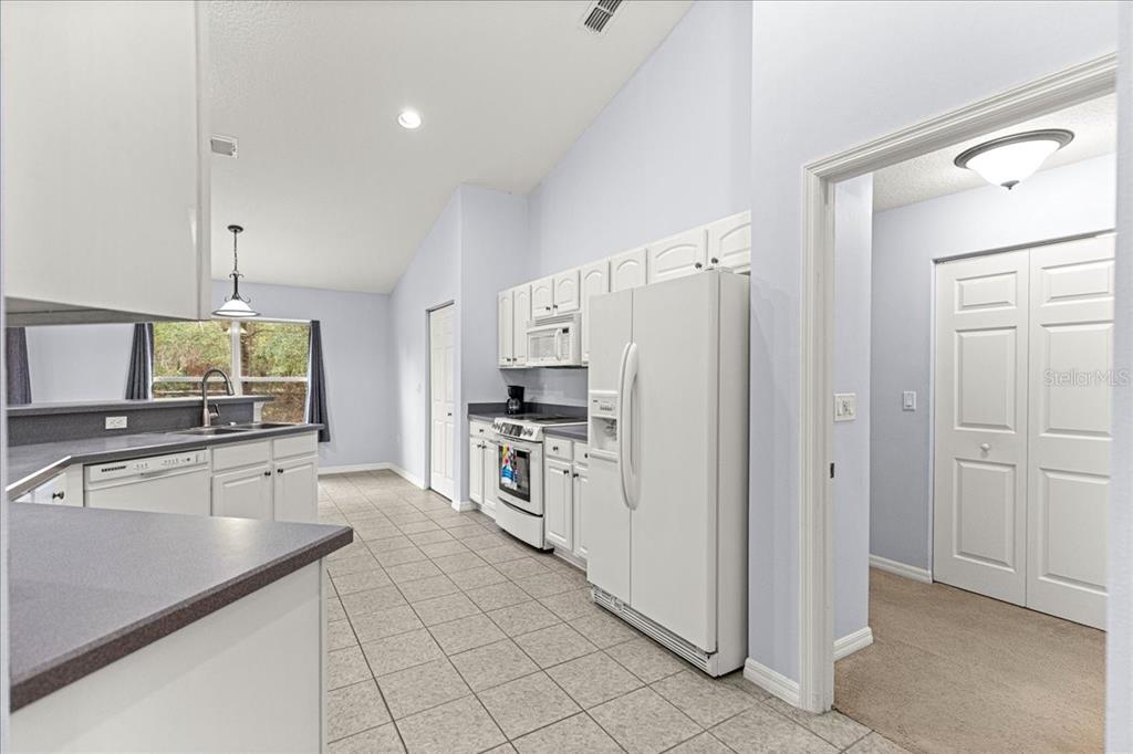 21595 Southwest 84th Loop Dunnellon, FL 34431 - Photo 14 of 62 a kitchen with stainless steel appliances a refrigerator sink and stove