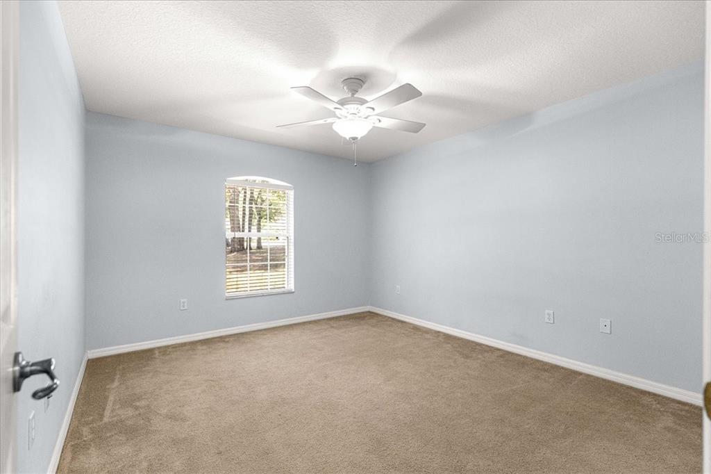 21595 Southwest 84th Loop Dunnellon, FL 34431 - Photo 25 of 62 an empty room with windows and fan