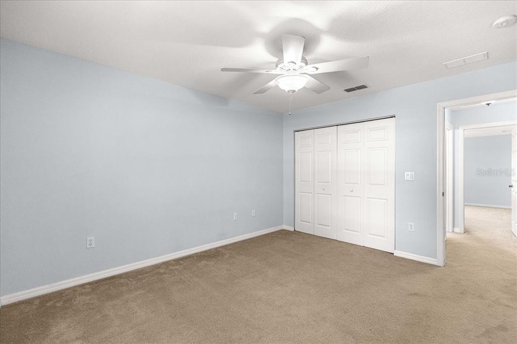 21595 Southwest 84th Loop Dunnellon, FL 34431 - Photo 26 of 62 an empty room with a chandelier fan and closet