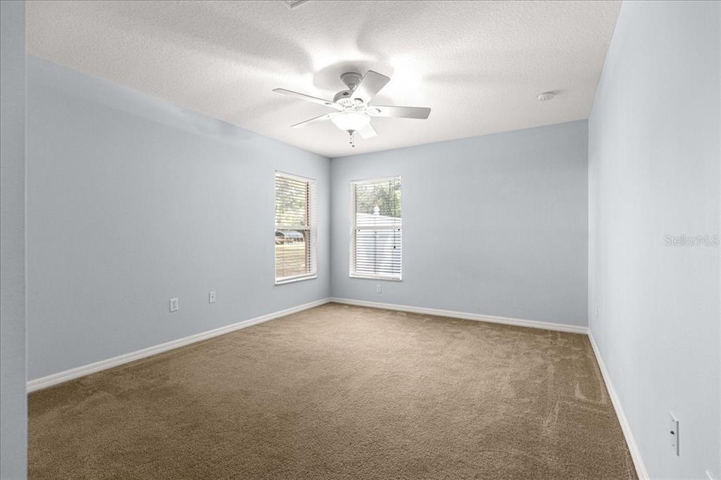 21595 Southwest 84th Loop Dunnellon, FL 34431 - Photo 29 of 62 an empty room with windows and fan