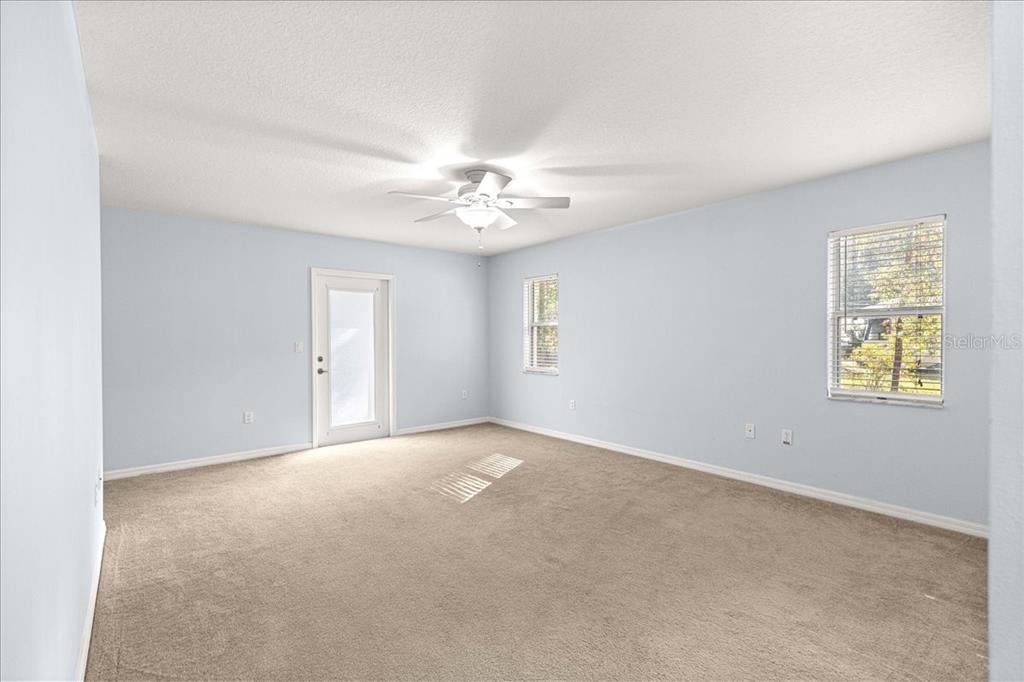 21595 Southwest 84th Loop Dunnellon, FL 34431 - Photo 31 of 62 an empty room with windows and fan