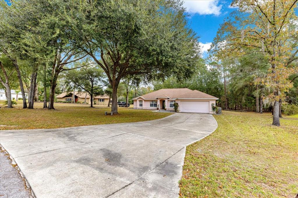 21595 Southwest 84th Loop Dunnellon, FL 34431 - Photo 52 of 62 a view of a house with a yard and tree s