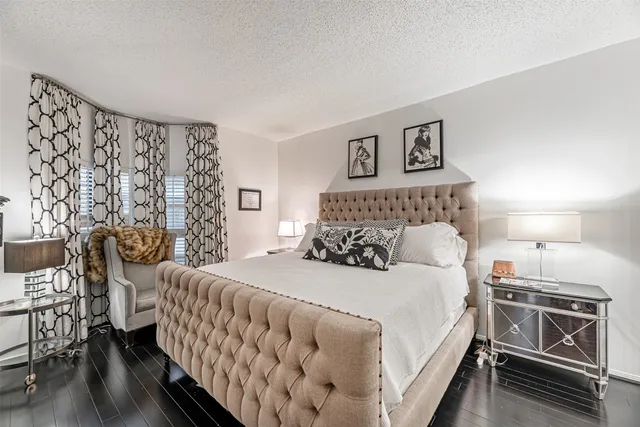 a bedroom with a bed and a night stand