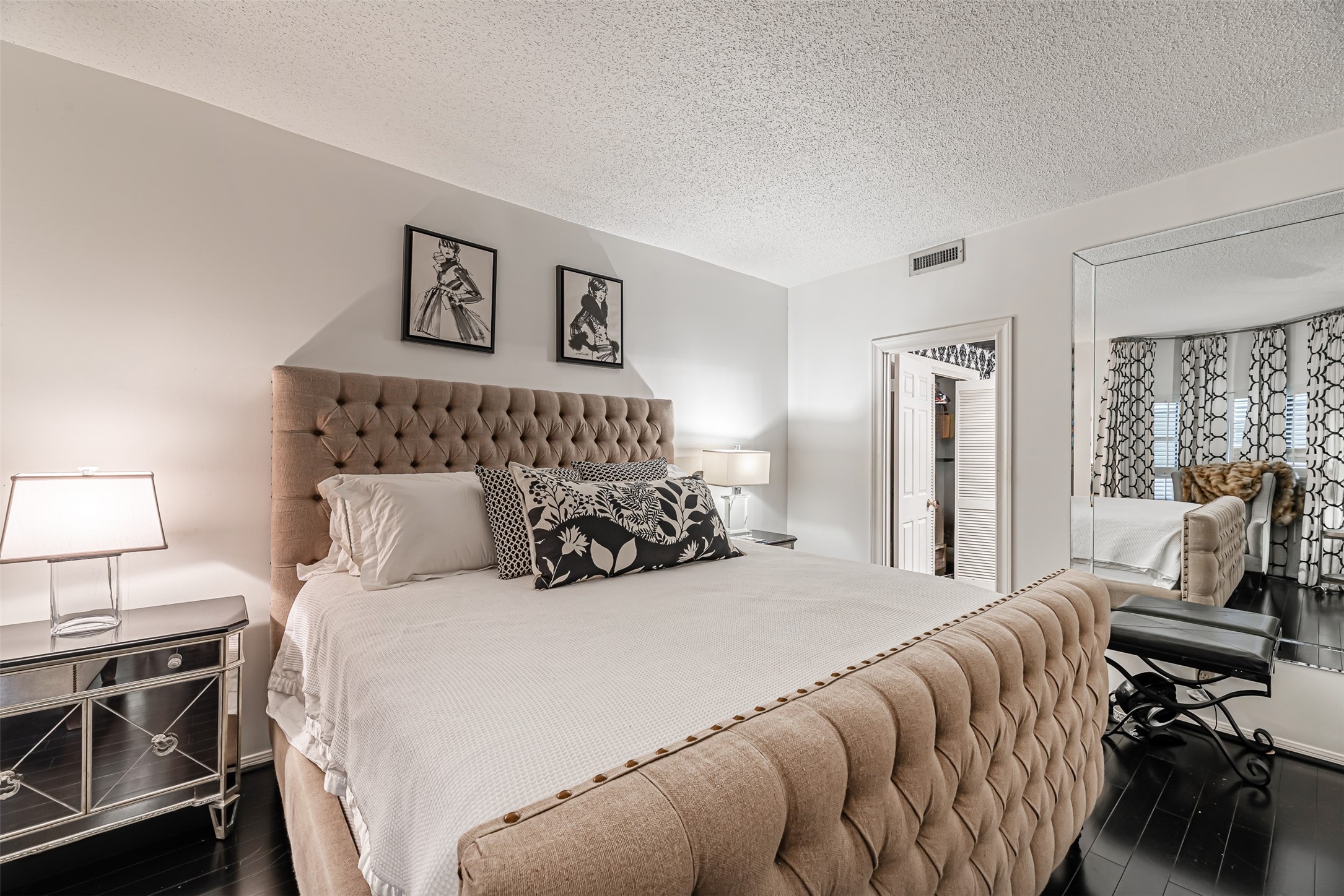 661 Bering Drive, Unit 404 Houston, TX 77057 - Photo 14 of 28 a bedroom with a bed and wooden floor