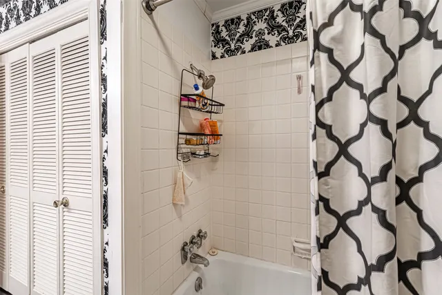 a bathroom with a bathtub and shower