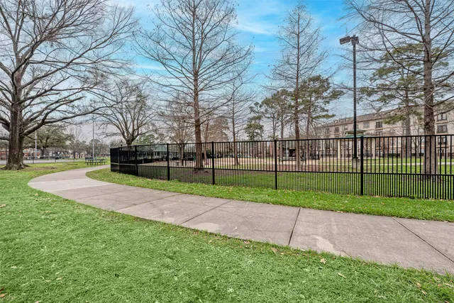 a view of a park with iron fence