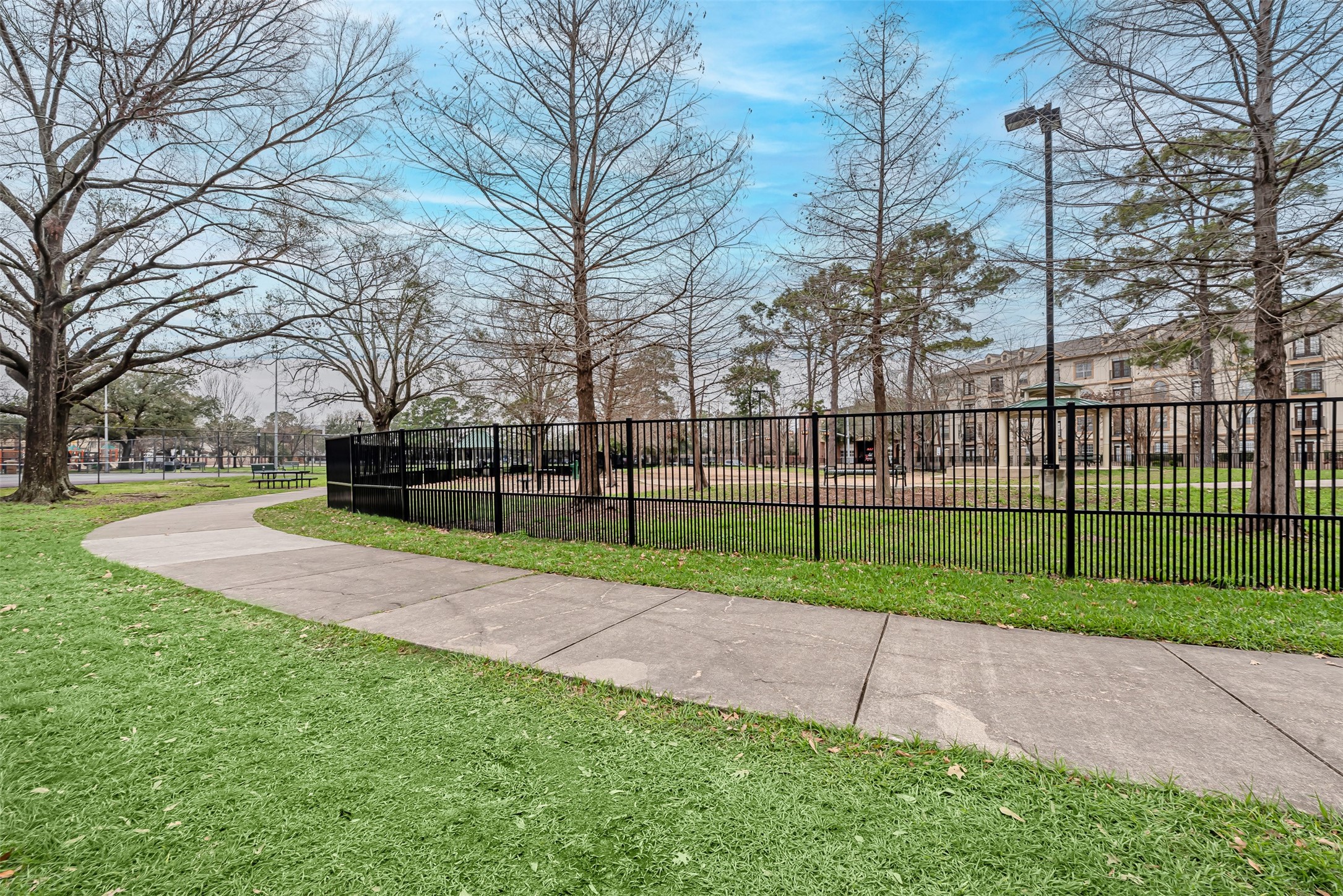 661 Bering Drive, Unit 404 Houston, TX 77057 - Photo 27 of 28 a view of a park with iron fence