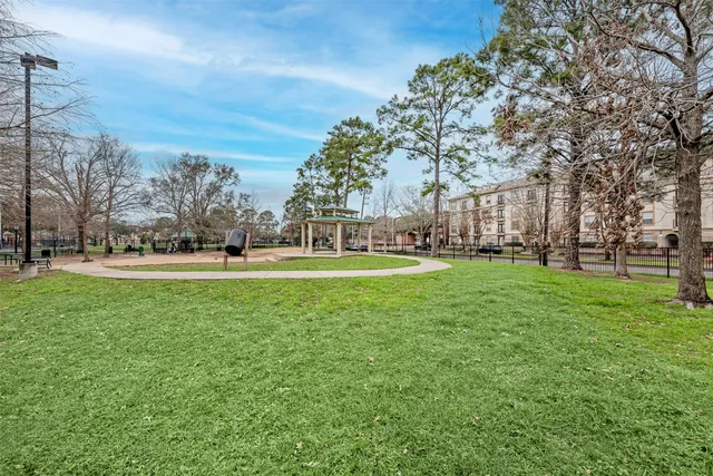 a green field with lots of trees