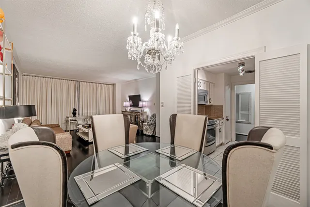 a view of a dining room with furniture and chandelier