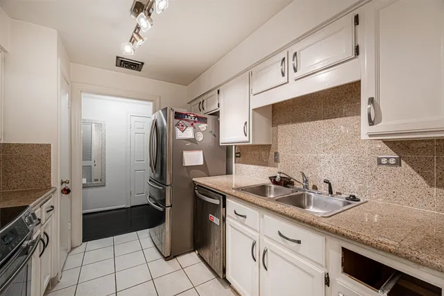 a kitchen with a sink cabinets and stainless steel appliances