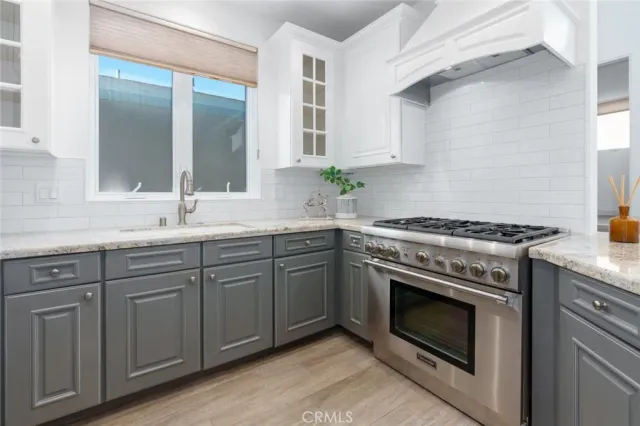 a kitchen with cabinets appliances and a sink