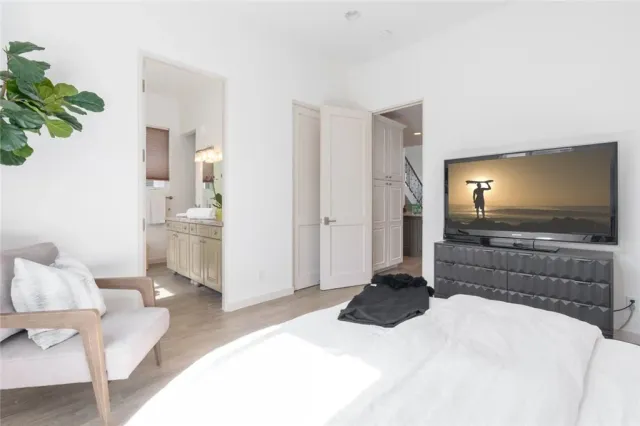 a living room with a flat screen tv furniture and a lamp