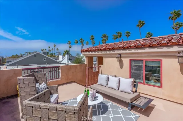 a view of a patio with couches and potted plants