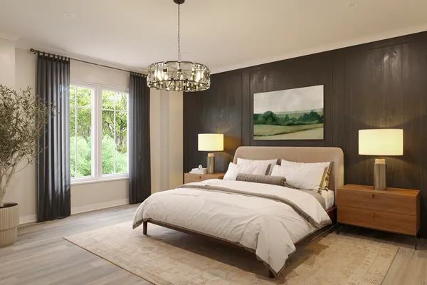 a bedroom with a large bed and a chandelier