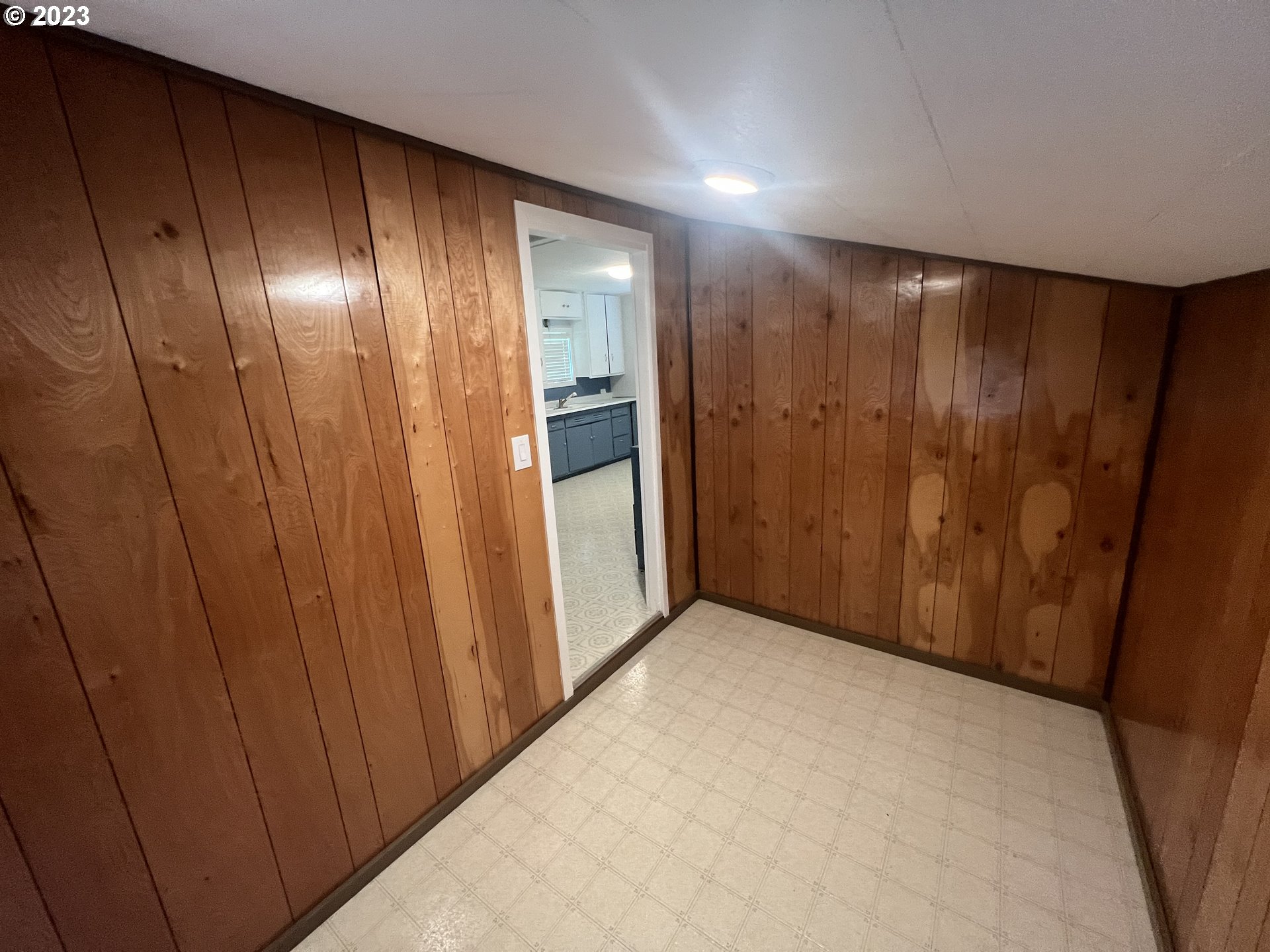 141 Poplar Street Powers, OR 97466 - Photo 10 of 14 a view of an empty room with wooden walls