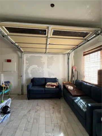 a bedroom with furniture and a window