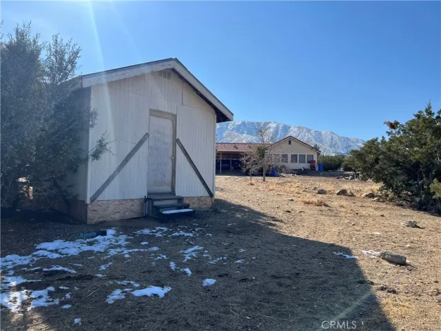 a view of a dirt road with a building in the background