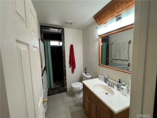 a bathroom with a sink vanity and a toilet