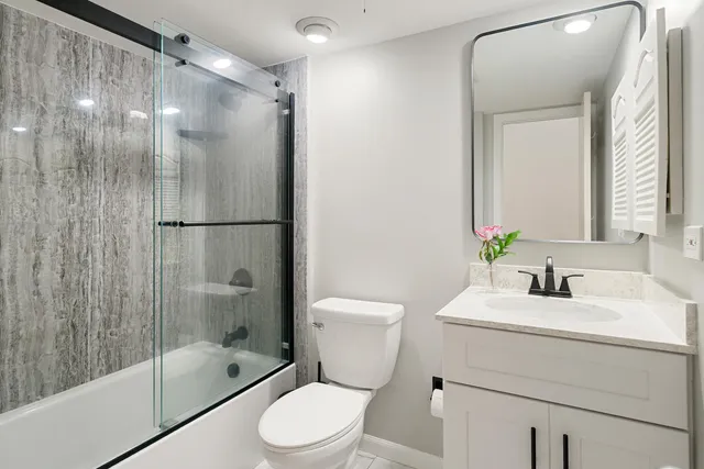 a bathroom with a sink toilet and shower