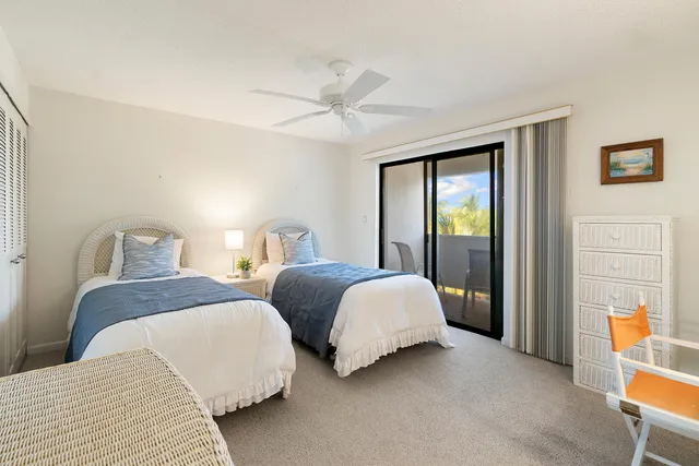 a bedroom with two beds and a window