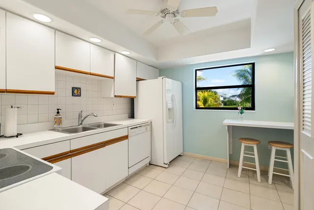 a kitchen with a sink appliances and cabinets
