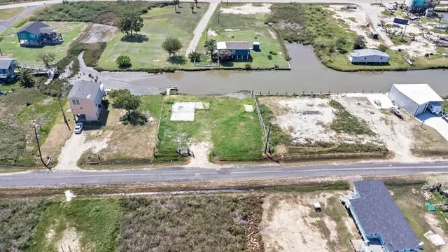 an aerial view of a house with a yard