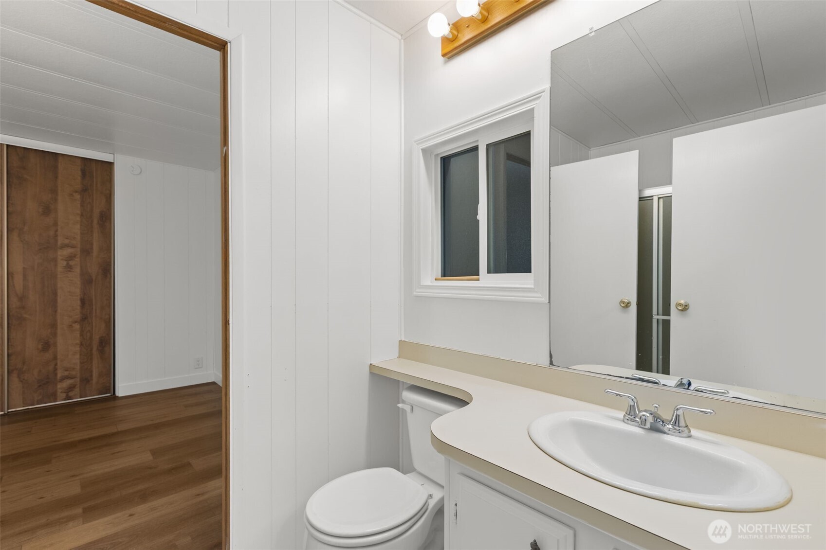 11436 Southeast 208th Street, Unit 7 Kent, WA 98031 - Photo 17 of 21 a bathroom with a toilet sink and mirror