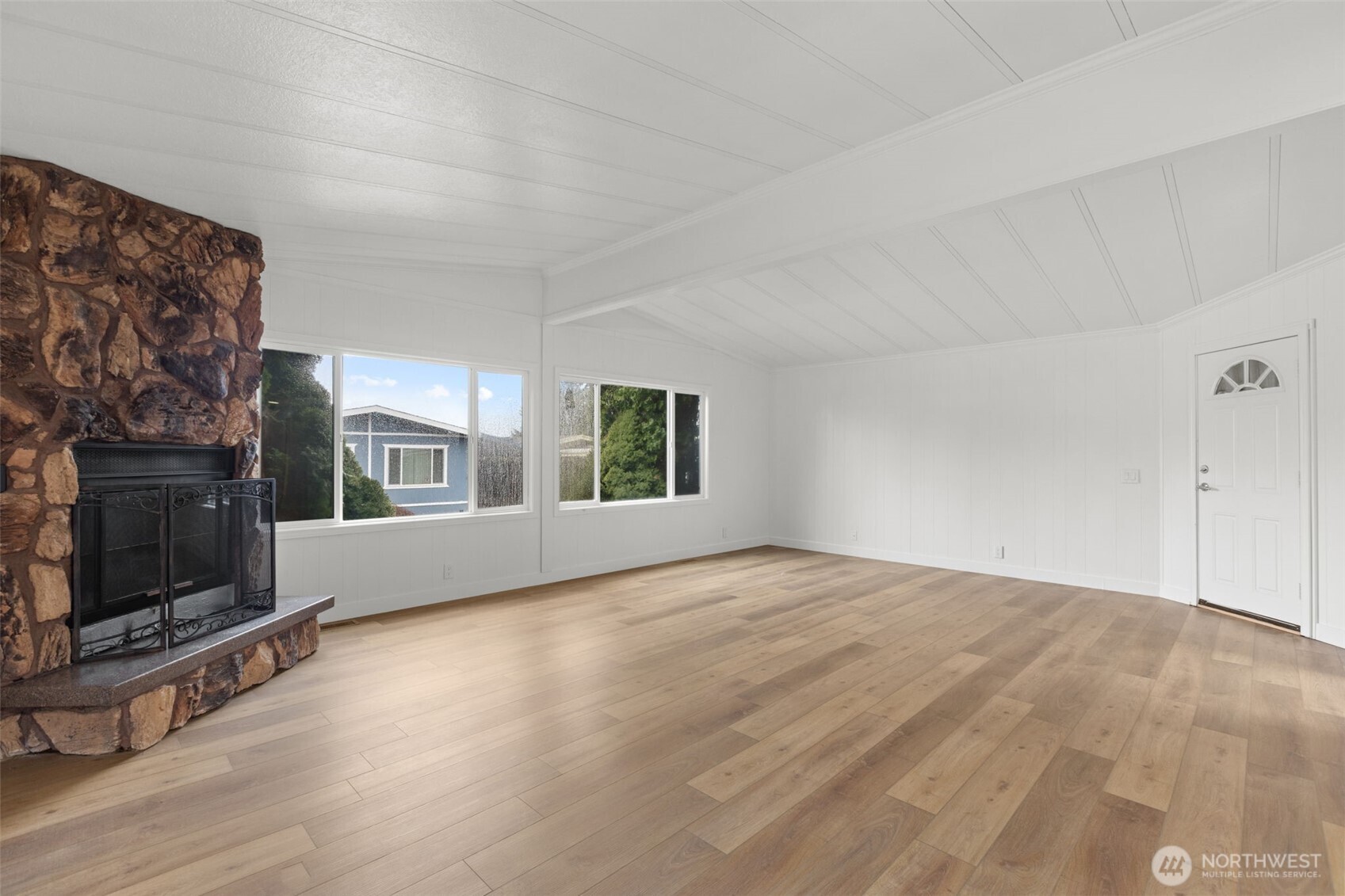 11436 Southeast 208th Street, Unit 7 Kent, WA 98031 - Photo 3 of 21 a view of an empty room with wooden floor fireplace and a window