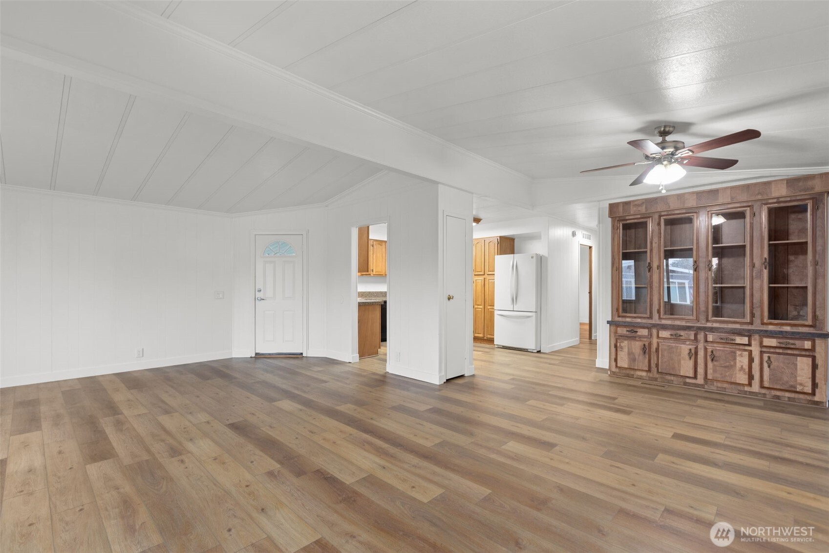 11436 Southeast 208th Street, Unit 7 Kent, WA 98031 - Photo 5 of 21 a view of an empty room with window and wooden floor