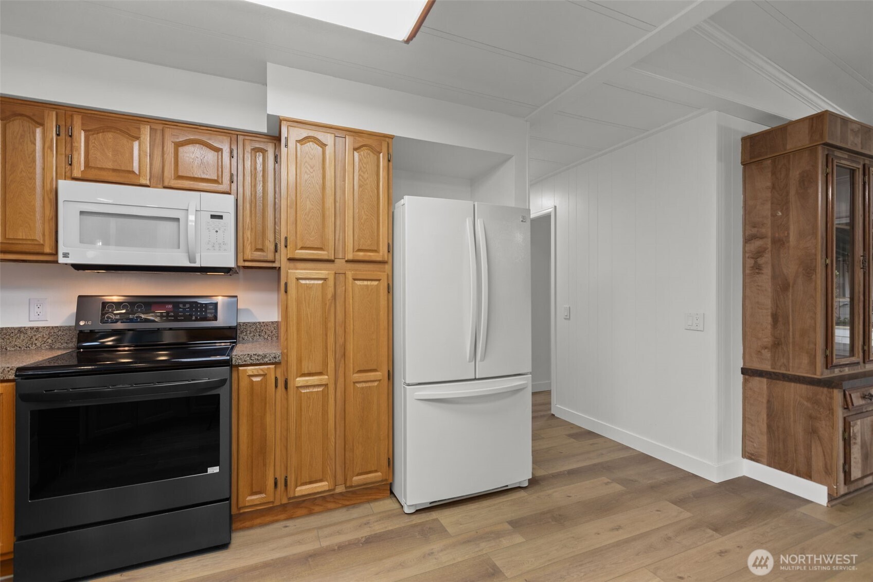 11436 Southeast 208th Street, Unit 7 Kent, WA 98031 - Photo 8 of 21 a kitchen with a refrigerator stove and wooden cabinets