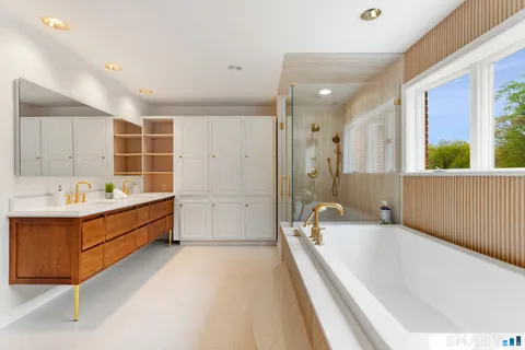 a bathroom with a bathtub a sink and a shower