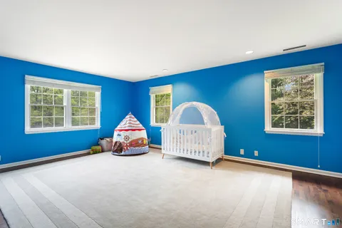 a blue bed sitting in a room next to a window