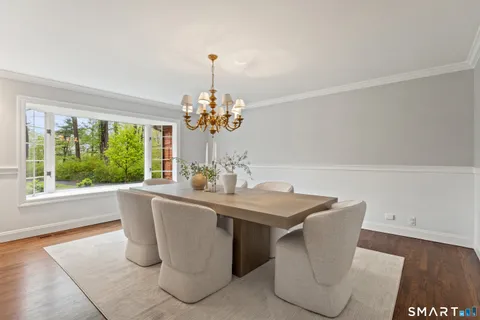 a dining room with furniture a window and a chandelier
