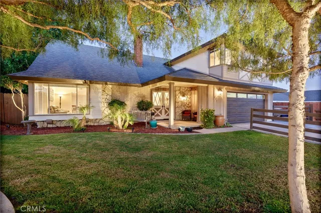 a view of a backyard with table and chairs under an umbrella