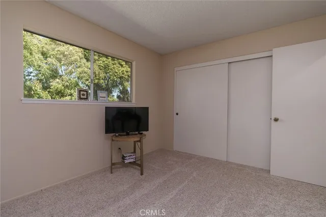 a view of a livingroom with workspace and a window