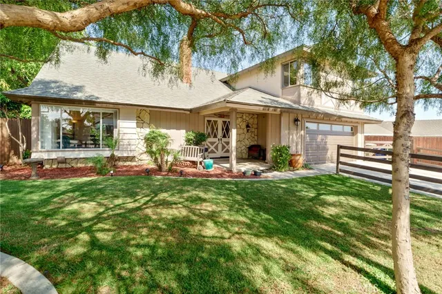 a view of a patio with table and chairs under an umbrella