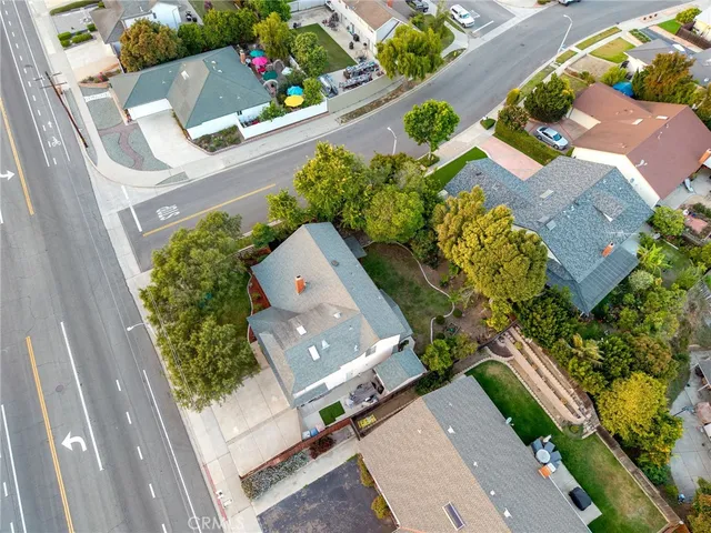 an aerial view of a house with a yard and potted plants