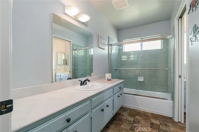 a bathroom with a tub sink and mirror