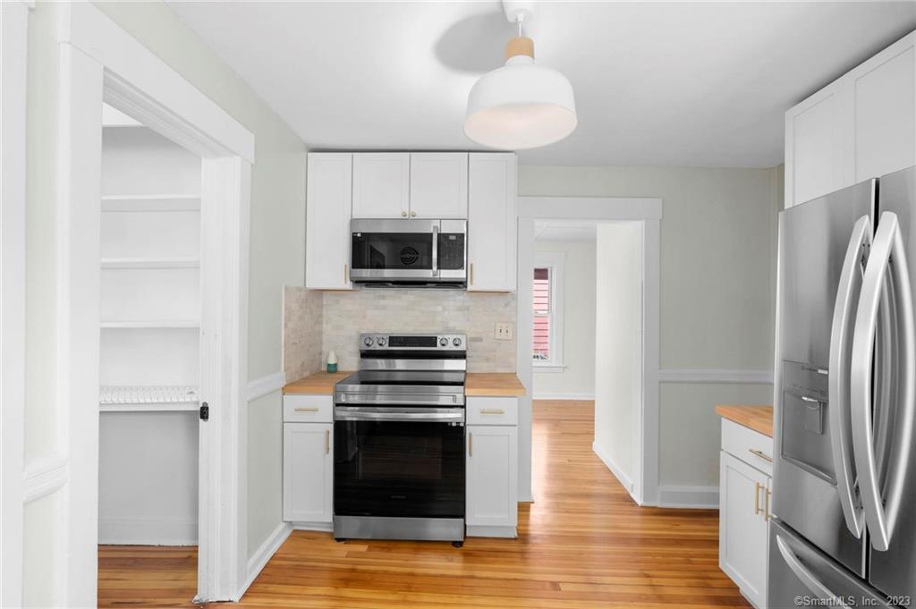 22 Sycamore Lane Waterbury, CT 06705 - Photo 15 of 31 a kitchen with stainless steel appliances a stove microwave and a refrigerator