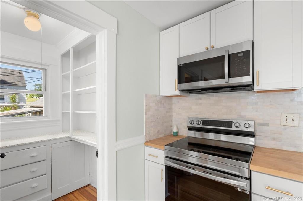 22 Sycamore Lane Waterbury, CT 06705 - Photo 18 of 31 a kitchen with white cabinets and stainless steel appliances