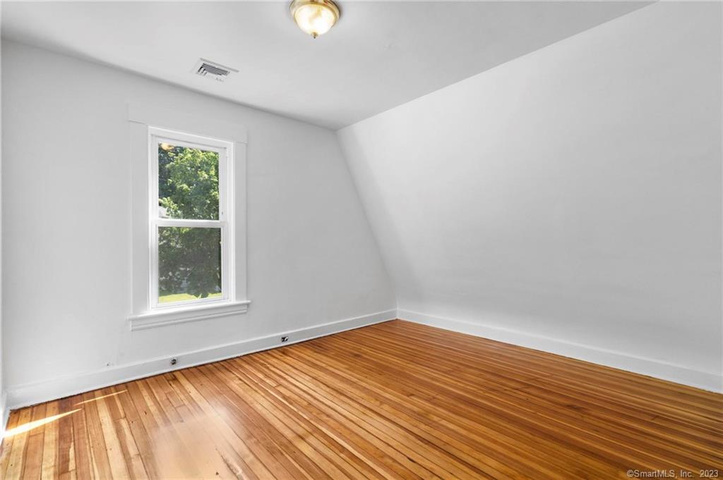 22 Sycamore Lane Waterbury, CT 06705 - Photo 26 of 31 an empty room with wooden floor and windows