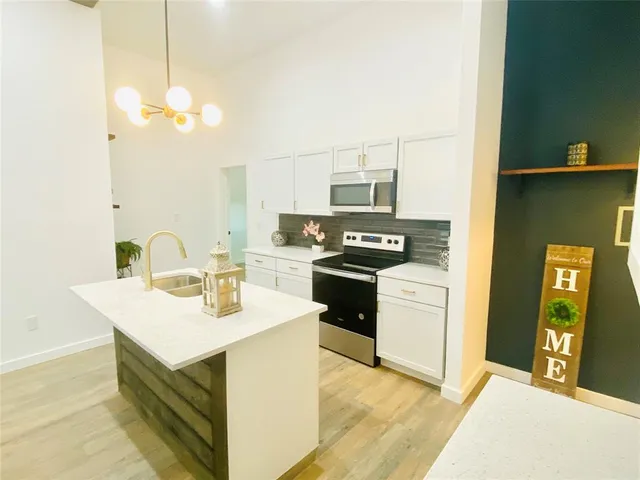 a kitchen with sink and stove