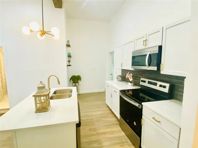 a kitchen with a stove and a sink