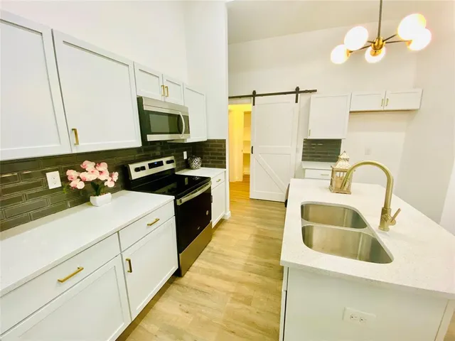 a view of kitchen with furniture and a potted plant