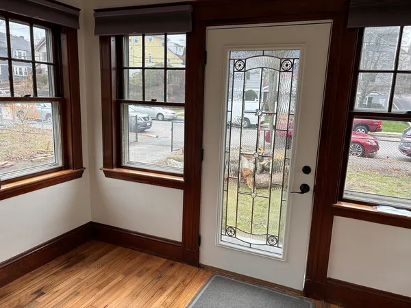 a view of an entryway with wooden floor and door