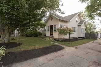 a view of a house with yard and a garden