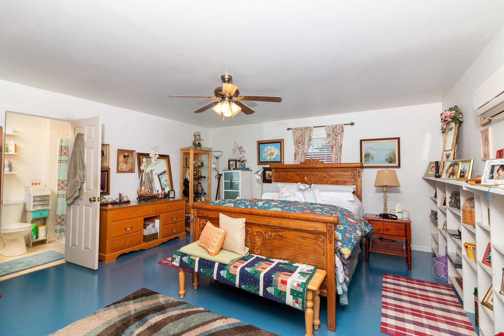 515 Blooming Grove Road Pulaski, TN 38478 - Photo 13 of 30 a bedroom with furniture and a book shelf