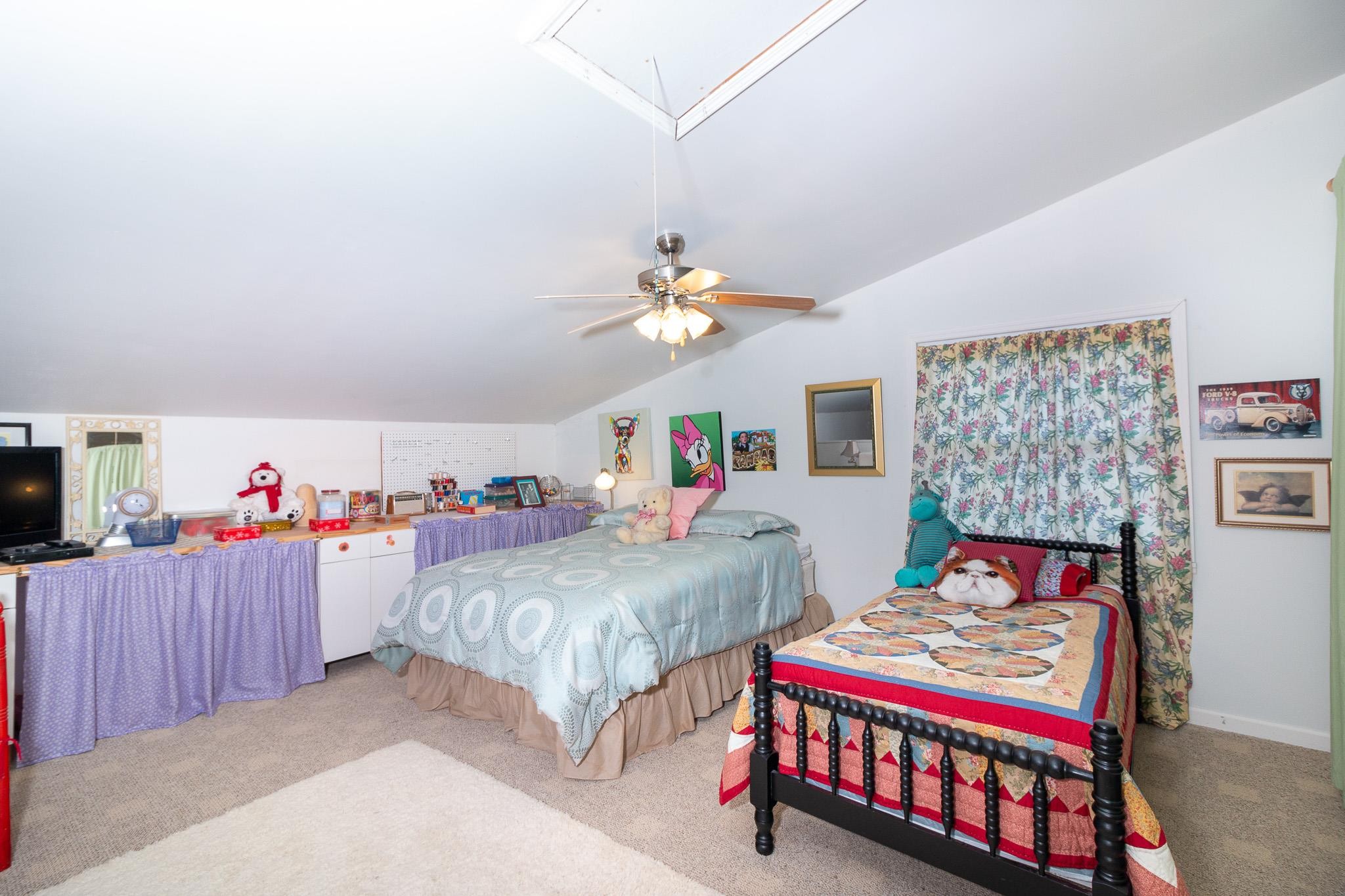 515 Blooming Grove Road Pulaski, TN 38478 - Photo 14 of 30 a bedroom with two beds and a chandelier