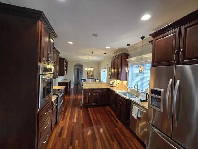 a kitchen with stainless steel appliances a refrigerator a stove a sink and a stove